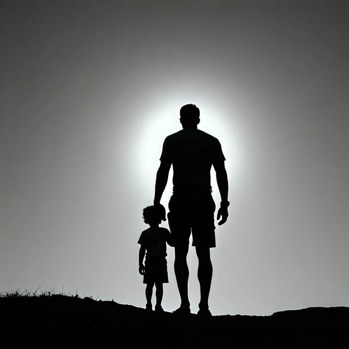 Silhouette of father and child outdoors at sunset, celebrating Father's Day