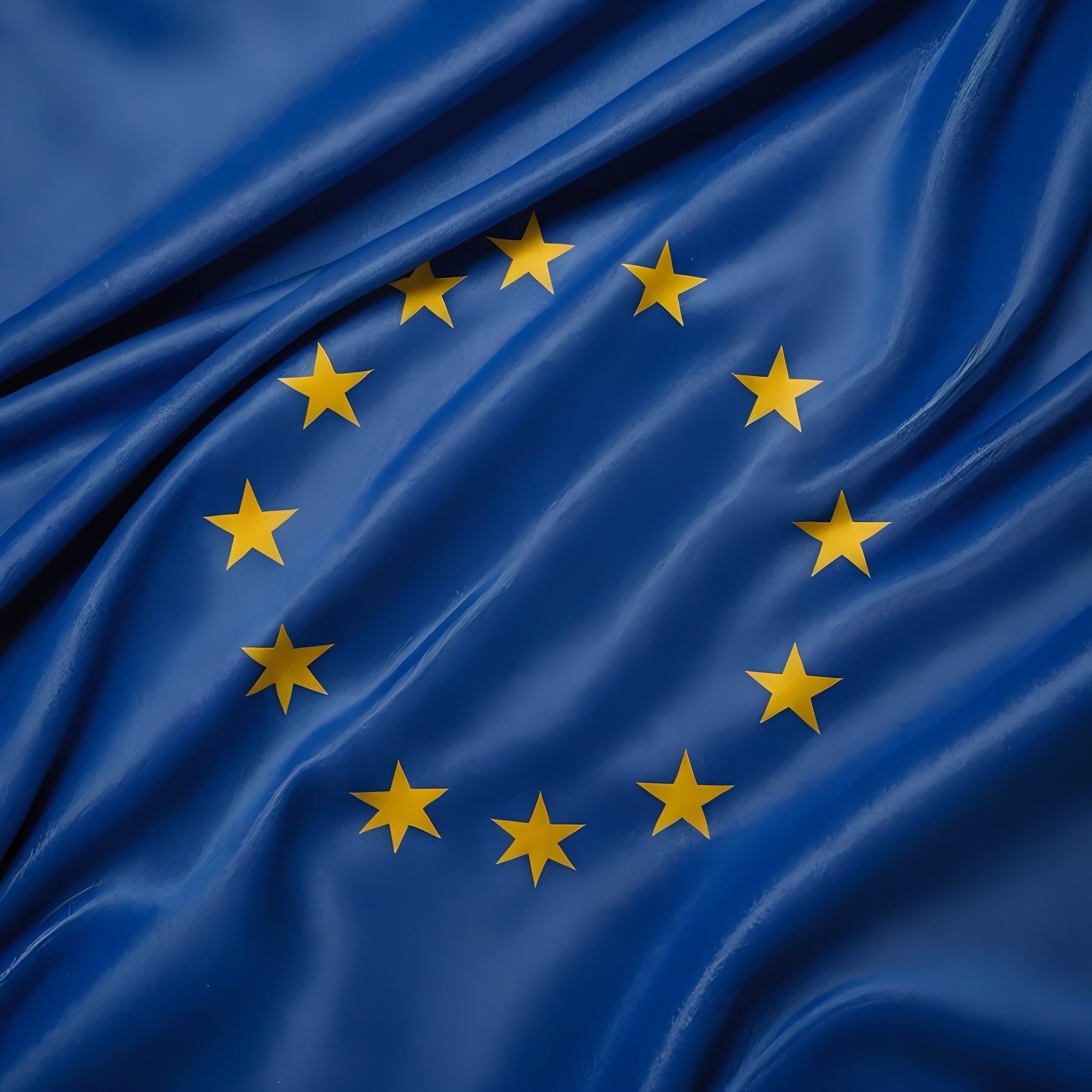 European Union flag with yellow stars on blue fabric background