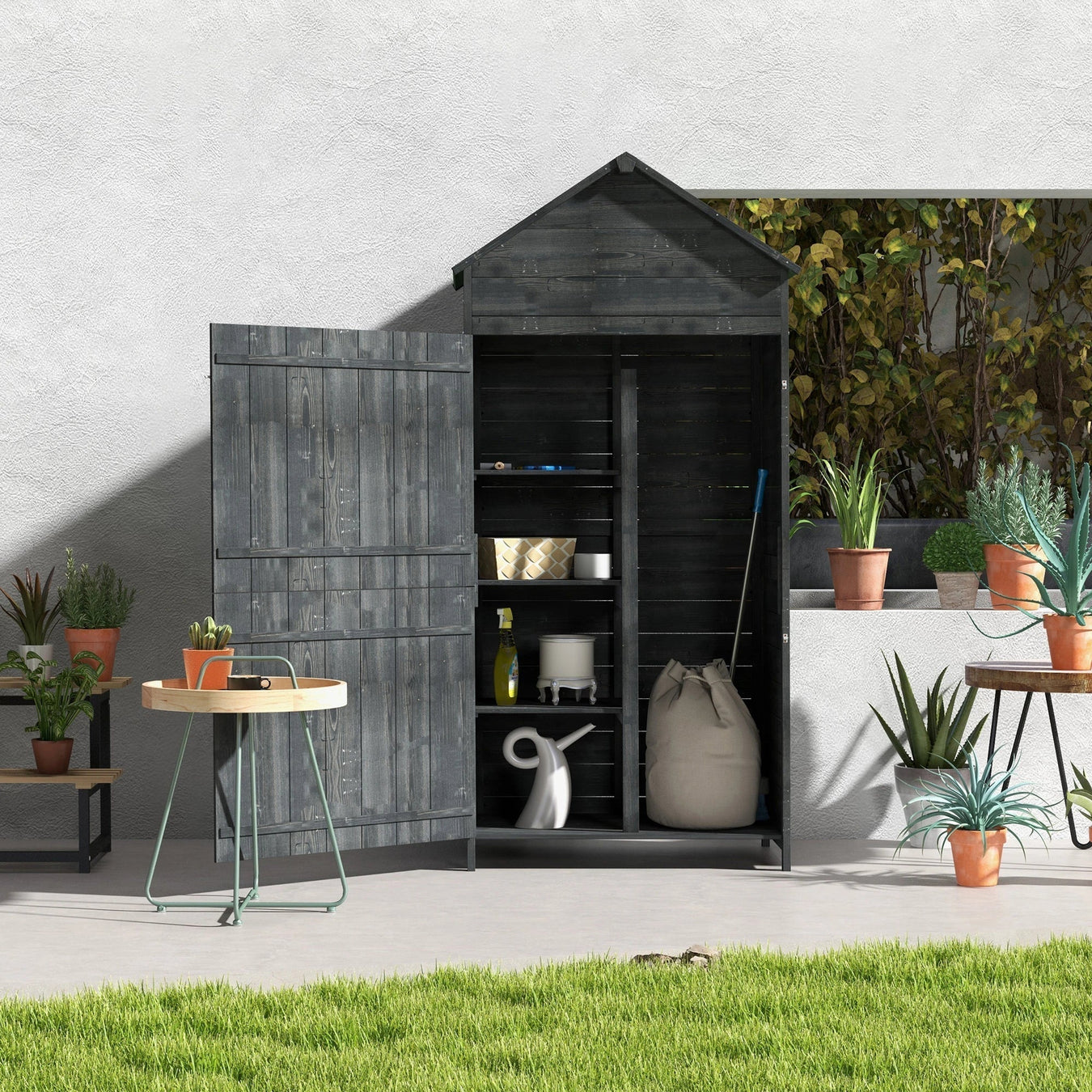 Black wooden garden shed with open doors, shelves, potted plants, and gardening tools outside.