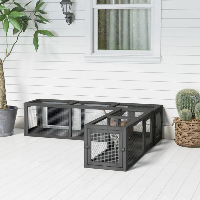 Outdoor black metal mesh cat run with attached shelter on white porch with plants and window