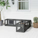 Outdoor black metal mesh cat run with attached shelter on white porch with plants and window