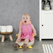 Child sitting on a potty chair in a bathroom setting