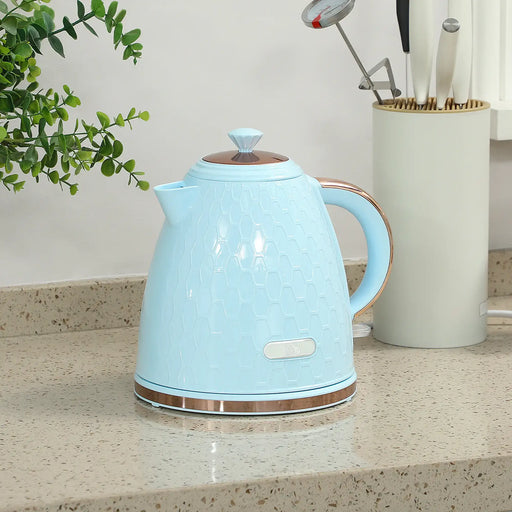 Light blue electric kettle on a kitchen counter with a plant and utensils in the background.