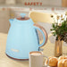 Blue electric kettle on a kitchen counter with a cup of coffee and pastries, featuring safety features.