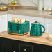 Teal toaster and kettle on a kitchen counter with white cabinets and decorative items.