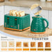 Green toaster with four slices of toast and a matching kettle on a kitchen counter.