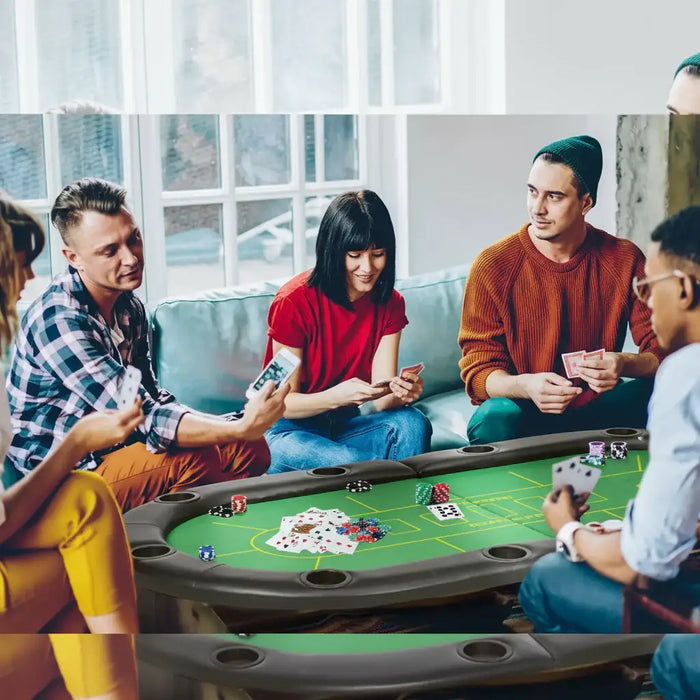 Group of people playing cards at a green felt 10-player folding poker table with cup holders.