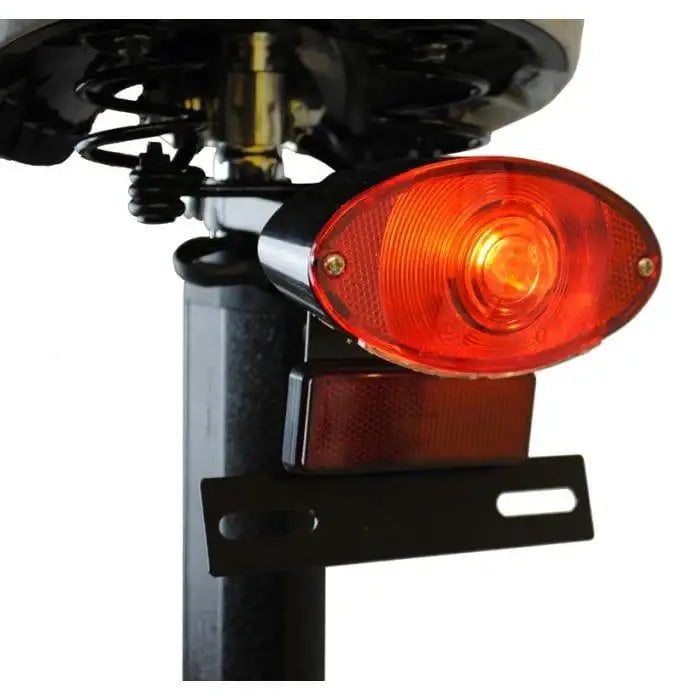 Close-up of electric scooter rear light, suspension, and reflector details