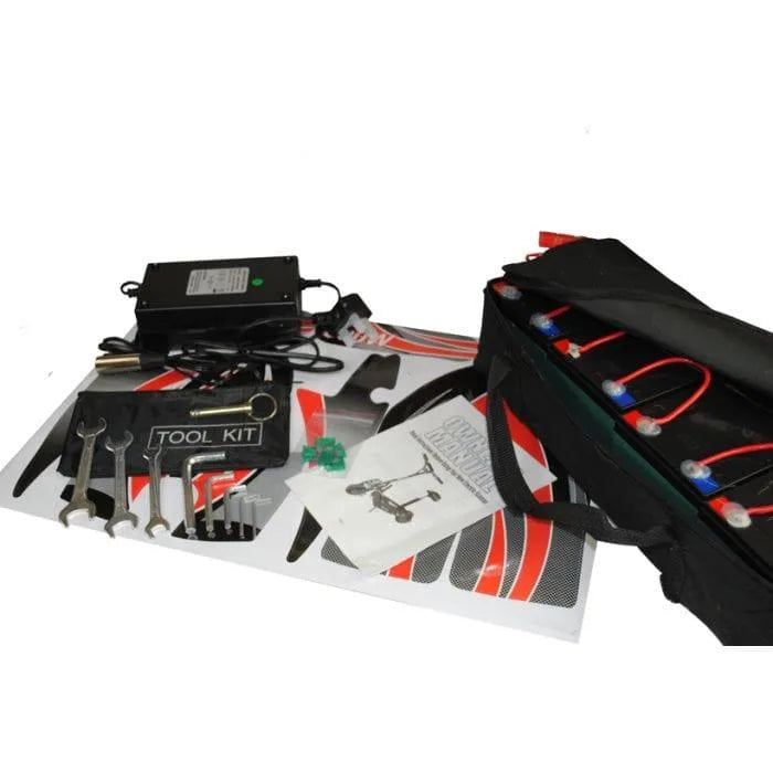 Electric scooter toolkit with wrenches, battery pack, charger, manual, and stickers