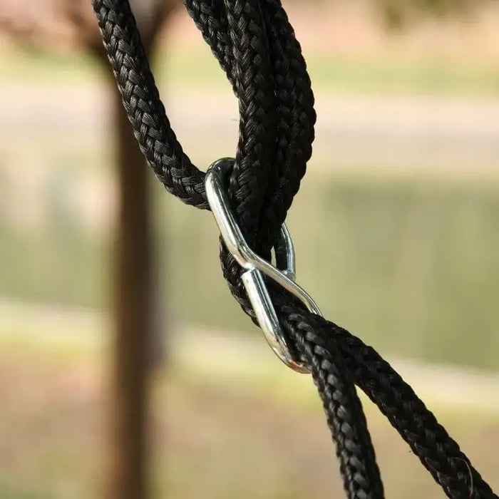 Close-up of black adjustable rope with metal clip for outdoor garden tree swing