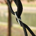 Close-up of black adjustable rope with metal clip for outdoor garden tree swing