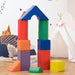 Multi-coloured foam geometric shape set for kids, arranged as blocks in a playroom.