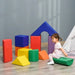 Child playing with colorful foam shape set, geometric educational blocks on floor