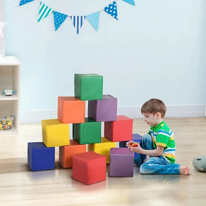 Child playing with 12-piece soft foam activity blocks in colorful playroom