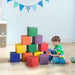 Child playing with 12-piece soft foam activity blocks in colorful playroom