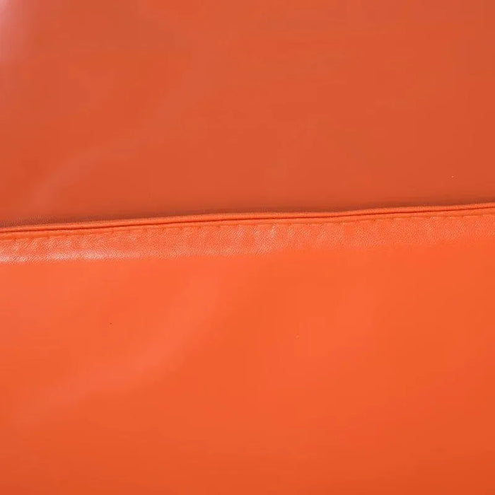 Close-up of orange soft foam activity play set block with visible seam detail