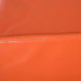 Close-up of orange soft foam activity play set block with visible seam detail