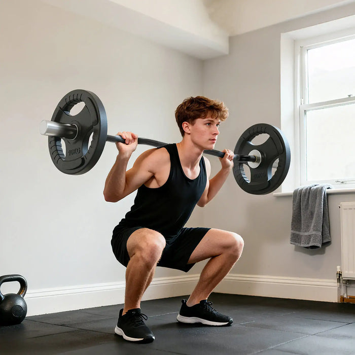 Man performing a barbell squat in a home gym setting.