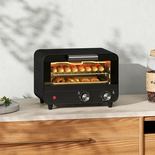 Black toaster oven with bread on a countertop
