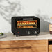 Black toaster oven with bread on a countertop