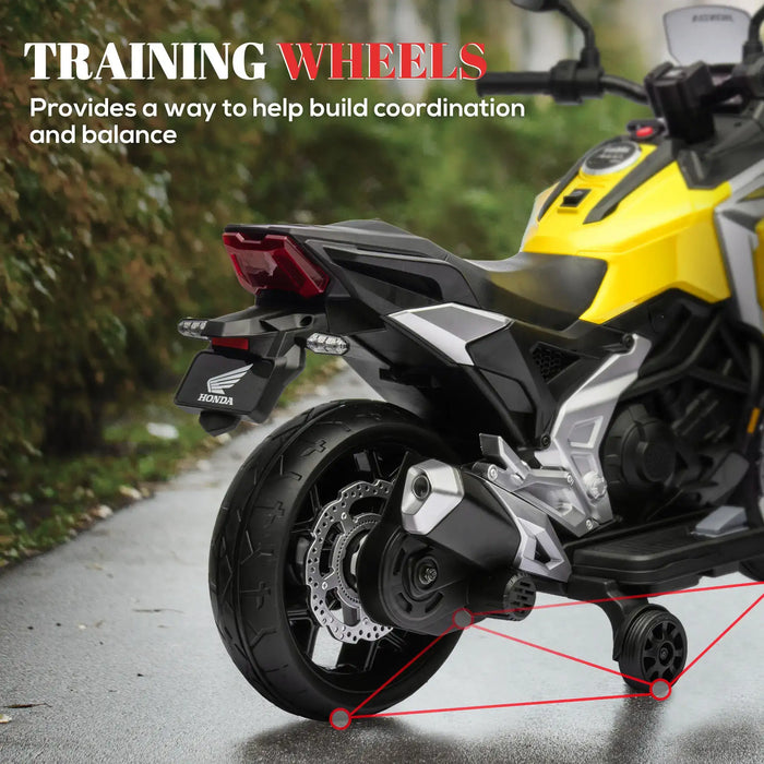 Close-up of a yellow and black Honda motorcycle rear wheel with attached training wheels on a wet pavement