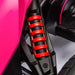 Close-up of red suspension spring on pink 12V kids electric go-kart ride-on vehicle