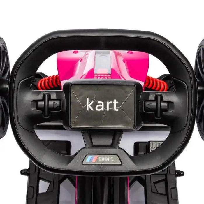 Close-up of pink kids electric go-kart steering wheel and dashboard controls