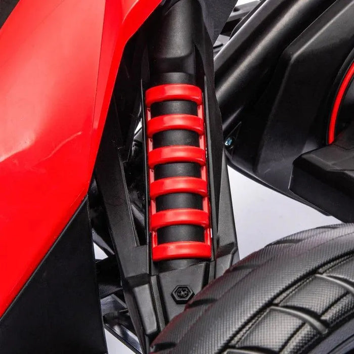 Close-up of red suspension spring and tire on 12V kids electric go kart ride-on