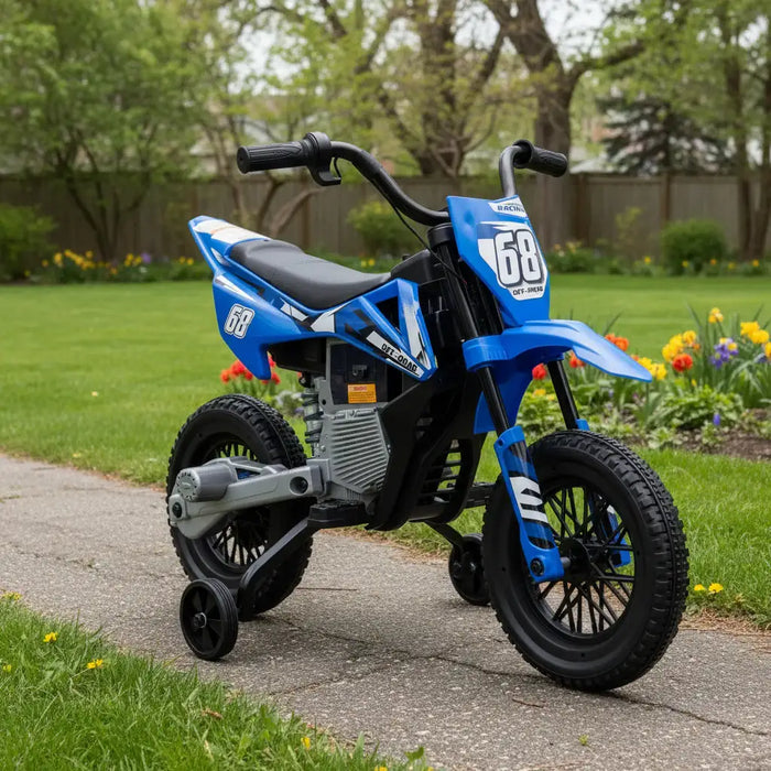 Blue kids electric dirt bike with training wheels on a garden path surrounded by green lawn and flowers