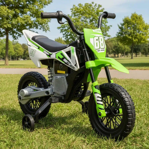Green and white electric kids dirt bike with training wheels on grass in park