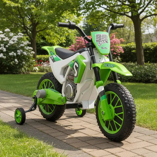 Green and white toy dirt bike with training wheels in a front garden setting surrounded by plants