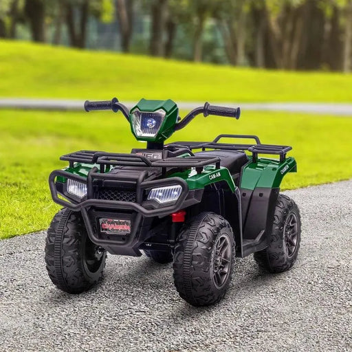Green and black kids electric quad bike with LED headlights on a paved path outdoors