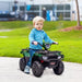 Child riding green and black 12V kids electric quad bike with LED headlights outdoors