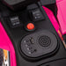 Close-up of control panel on pink kids electric quad bike with USB port and buttons