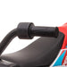Close-up of black handlebar grip on red 12V kids electric ride-on motorbike