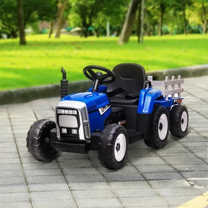 Blue 12V kids electric ride-on tractor with detachable trailer on a paved path in park