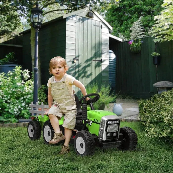 Child on green 12V kids electric ride-on tractor with detachable trailer in garden