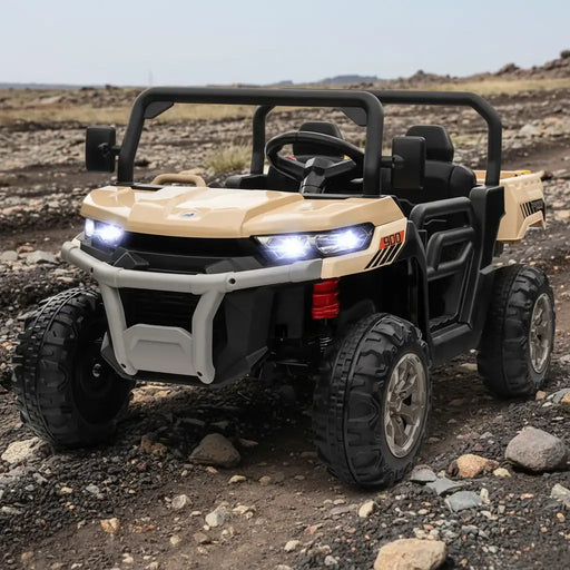 Yellow 12V kids electric ride-on UTV, rugged tires, LED headlights, outdoor rocky terrain