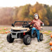 Child with hooded jacket standing on yellow 12V kids electric ride-on UTV outdoors in pumpkin patch