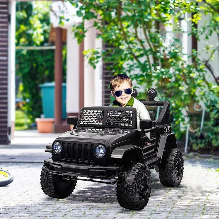Child driving black 12V kids off-road ride-on car with working doors outdoors