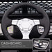 Close-up dashboard of black 12V kids ride-on car with steering wheel and control buttons