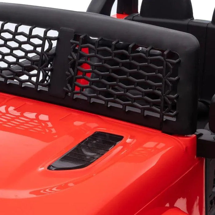 Close-up of red 12V kids off-road ride-on car with black mesh grille and detailed hood