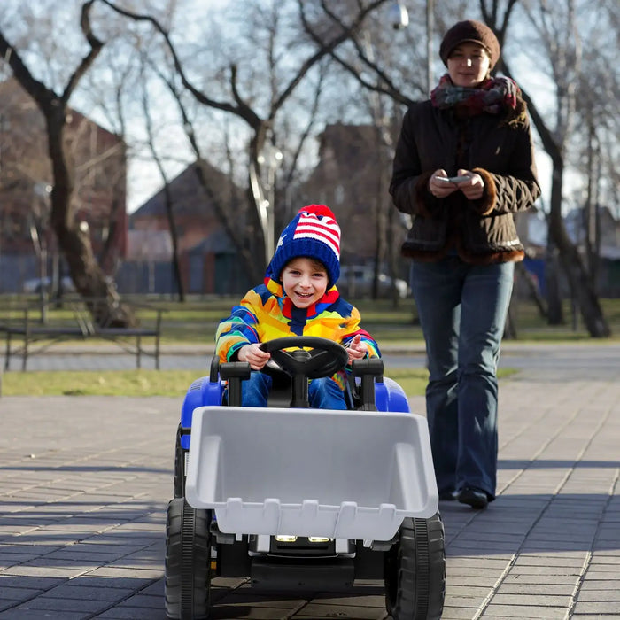 Child in a toy truck being pushed by an adult on a sidewalk