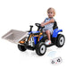 Child sitting in a toy construction vehicle with a remote control on a white background