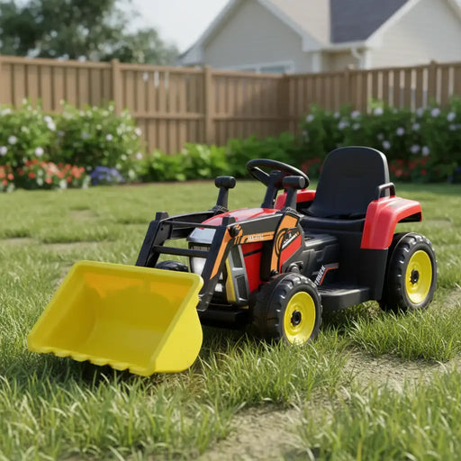 Child's toy tractor with a yellow front loader on grass
