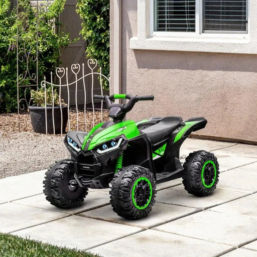 Green 12V kids ride-on quad ATV bike with LED headlights on patio near house window