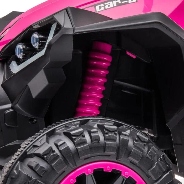 Close-up of pink 12V kids ride-on ATV quad bike tire, LED headlights, and shock absorber