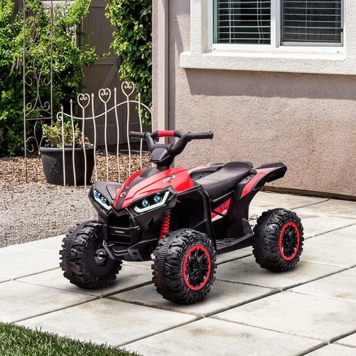 Red 12V kids ride on quad ATV bike with LED headlights on patio outdoors
