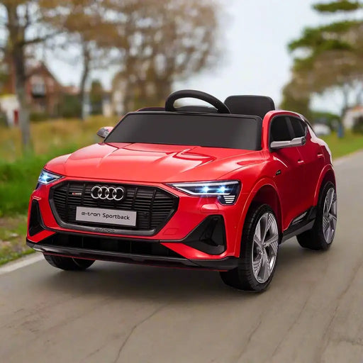 Red 12V Audi e-tron Sportback kids ride on car with LED lights on a paved road