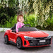 Child in a red Audi RS e-tron GT kids electric ride on car outdoors with flowers and greenery